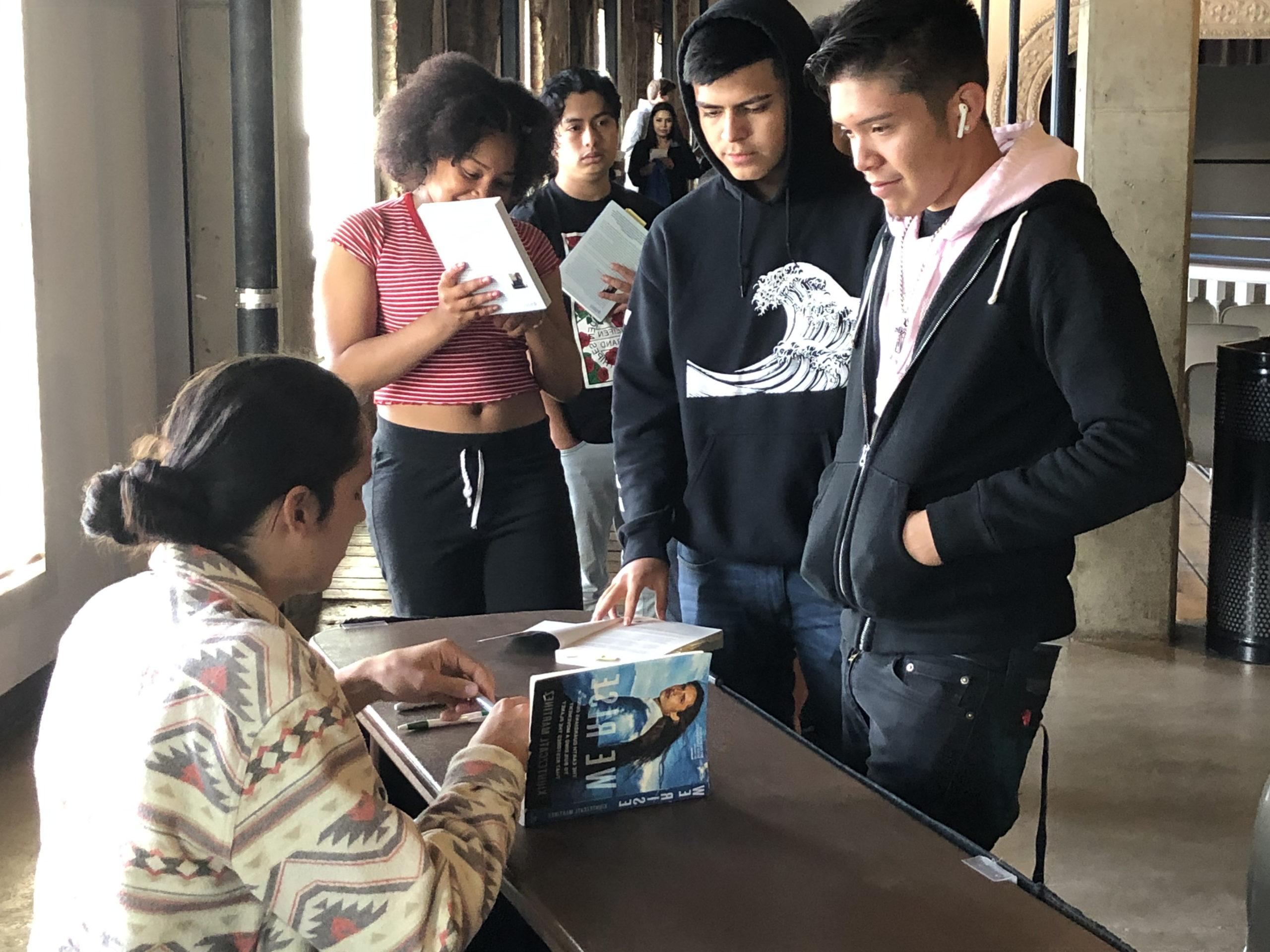 Xiuhtezcatl signing his book, 